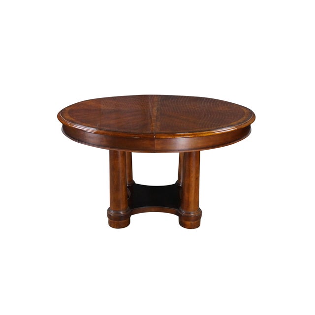 Vintage Ethan Allen American Empire style round extension dining table. Showcases a sophisticated, high-end design crafted...