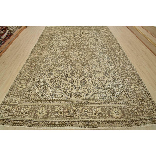 An authentic vintage traditional Tabriz rug hand-knotted with fine wool and natural dyes. This oriental rug features a...