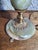 Table lamp with a translucent green onyx stem, veined with white and brown, turned into a pear-shaped vase. Italian or...