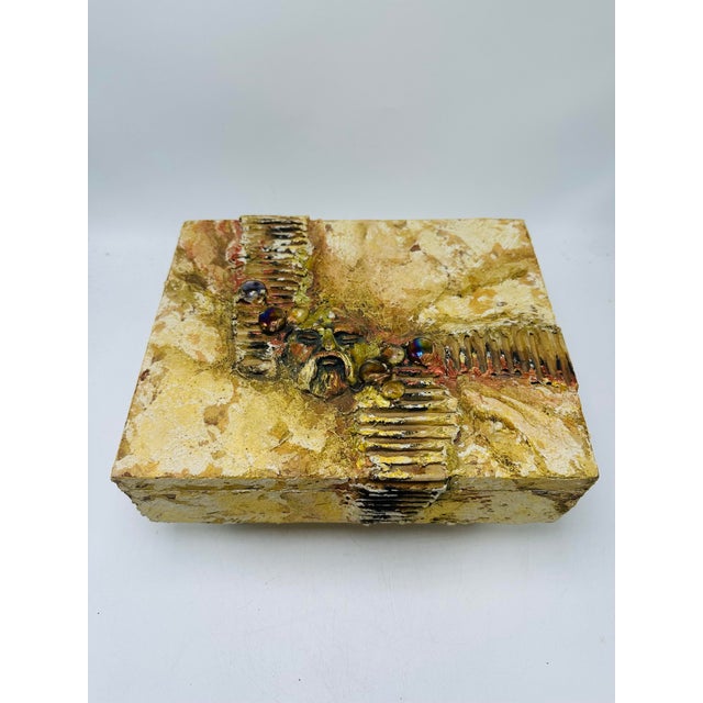 A one-of-a-kind handmade mixed-media art trinket box. The square box is painted in warm, earthy tones with a heavily...