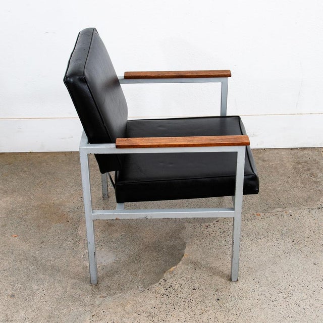 Classic Mid Century modern solid walnut and metal armchair. The entire frame is made up of metal with walnut arms. Very...