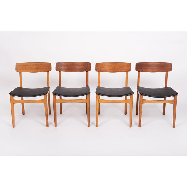 This set of four vintage mid century Danish modern teak wood dining chairs are circa 1960. These chairs have a classic...