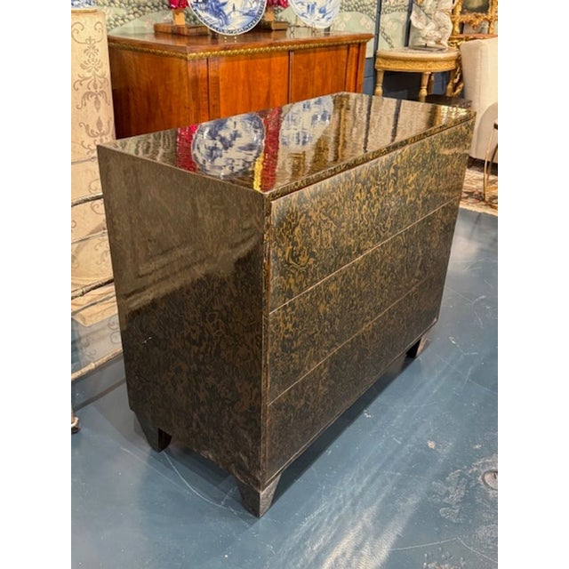 The Modern Art Deco Style Commode with a Mottled Tortoise Finish is a stylish and elegant piece of furniture that adds a...