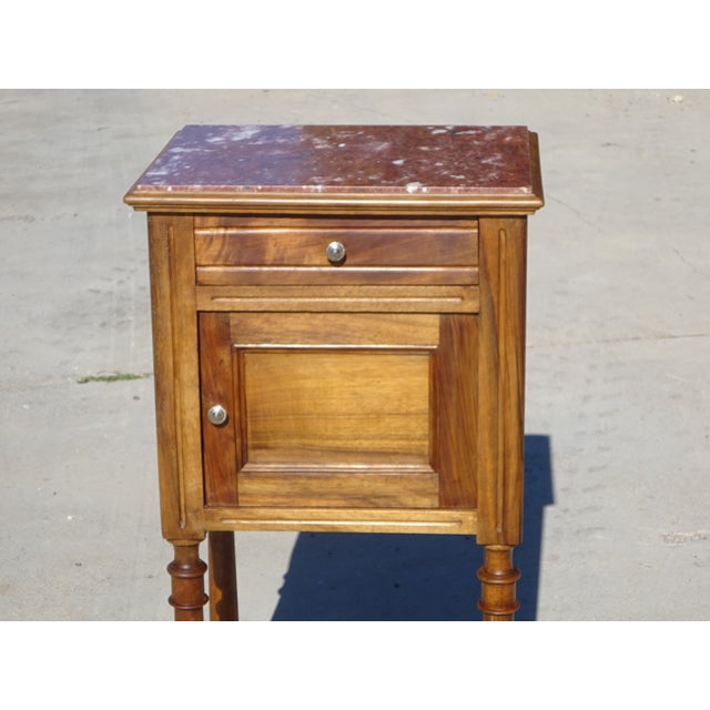 Very old bedside table, traditionally made in France from solid walnut, late 19th century. Brown marble top with white...