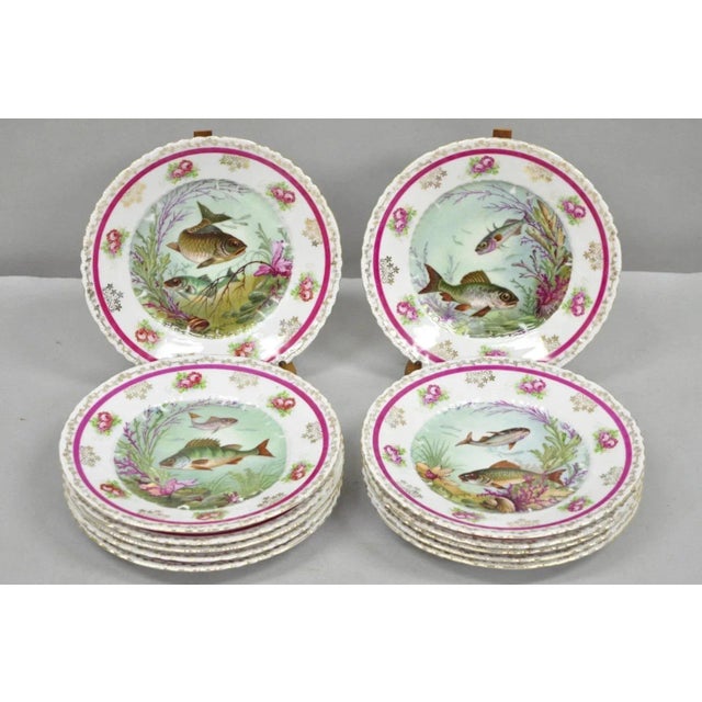 (12) Antique Victoria Carlsbad Austria 8 3/8" Hand Painted Porcelain Fish Plates and (1) Gravy Sauce Boat with Dish. Circa...