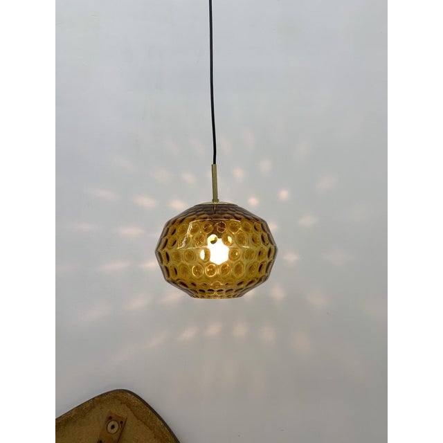 Limburg Glashütte hanging lamp with a great light effect once lit. Warm amber colored glass with golden holder. In good...