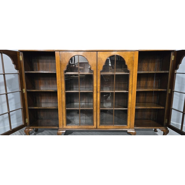 A very nice quality Queen Anne style four door walnut breakfront library bookcase, nine adjustable solid walnut shelves,...