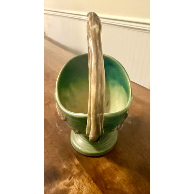 This basket exemplifies the Mid-Century Modern aesthetic of American Art pottery, making it a prized decorative item and...