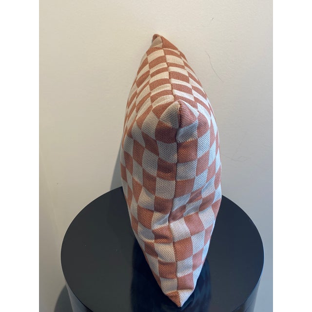This stylish square throw pillow features a timeless checkered pattern. The design consists of alternating terra cotta-...