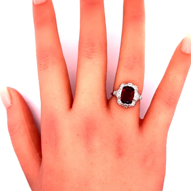 A captivating ruby, weighing approximately 3 carats, commands attention in this exquisite ring. The ruby, expertly cut in...
