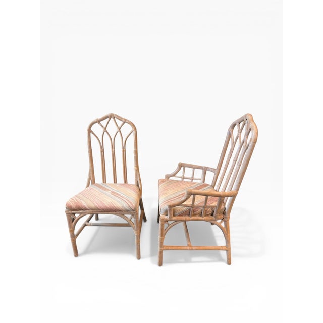 A striking set of eight vintage rattan dining chairs by Henry Link, including six side chairs and two armchairs. Designed...