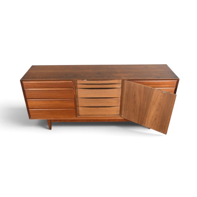 This thirteen drawer dresser was designed by Svend Åge Madsen and produced by Falster Møbelfabrik in Denmark during the...
