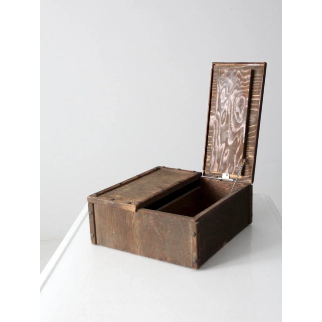 This rustic vintage wooden box, dating from the early to mid-20th century, is hand-built with craftsmanship and character....
