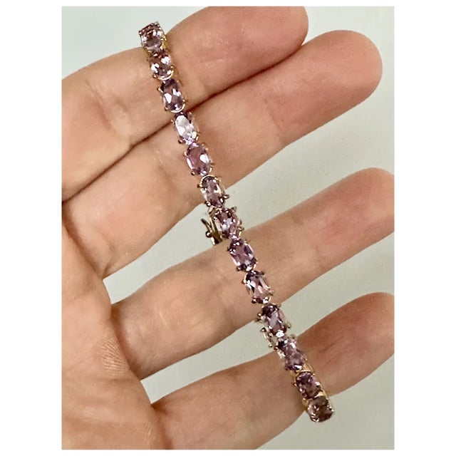 Sterling and gold vermeil tennis bracelet featuring 30 carats of faceted oval cut amethysts. The bracelet is larger length...