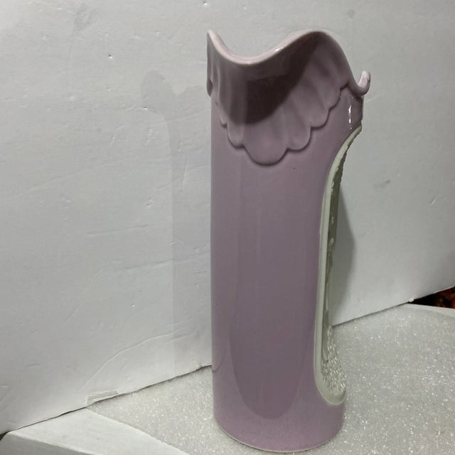 Glazed porcelain pitcher featuring bisque inset of a woman in bas relief