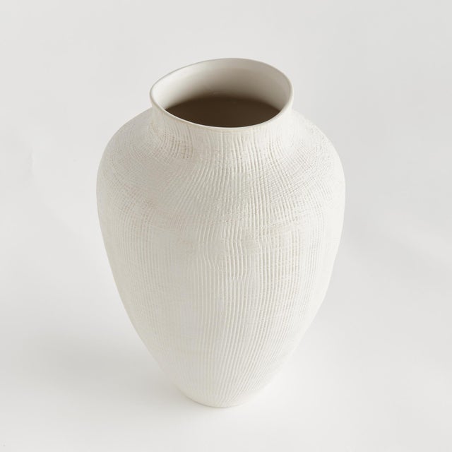 In a modern silhouette with a subtle crosshatch texture and matte finish, this ceramic vase is a stunning accent. Another...