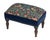 Meticulously handcrafted in the United Kingdom, this upholstered stool boasts classic studding and hand-polished solid...
