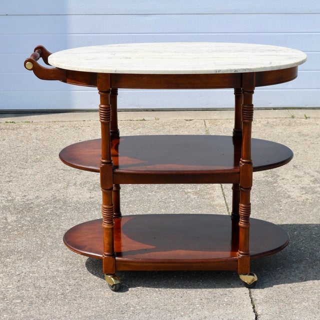 Wonderful rolling bar cart with marble top and brass accents by Pulaski furniture. I love the creamy marble top and the...