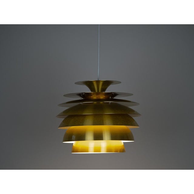 The Barcelona lamp by Bent Karlby is an elegant 1960s ceiling lamp made of aluminum. It features a minimalist, geometric...