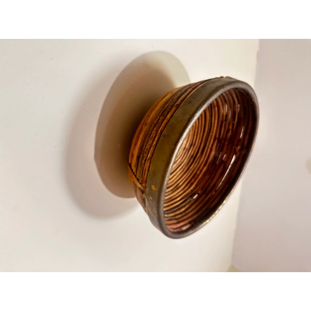 In the manner of Crespi, 1970s split reed with brass rim. Great as a catchall, instantly recognizable to most dealers....