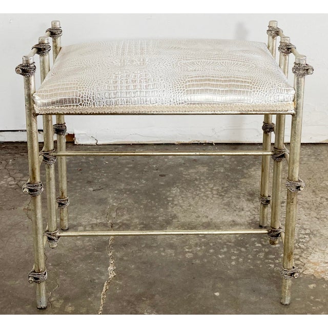 Vintage Hollywood Regency style gilt metal vanity bench with rope detail to frame. Wood bench is covered in a metallic...