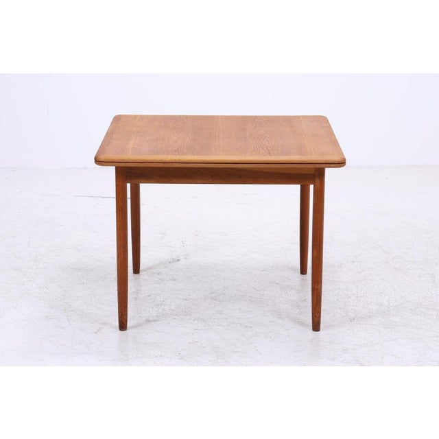 Vintage teak dining table with a practical extension mechanism and a beautifully grained tabletop. The restored surface,...