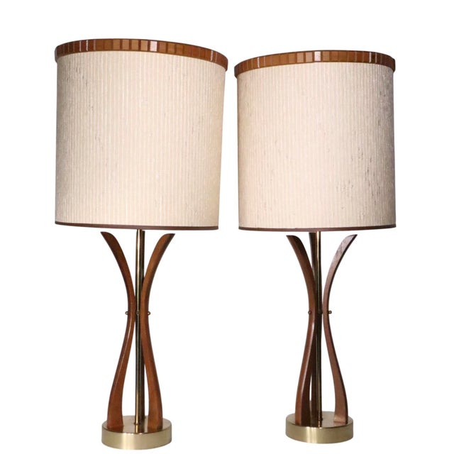 Sculptural pair of Mid Century wood and brass table lamps, in very good, clean, working and ready to use condition. The...