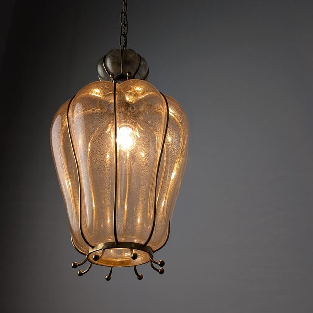 Mid-century lantern manufactured by barovier & toso. The piece consists of a main body of hand-blown murano glass with...