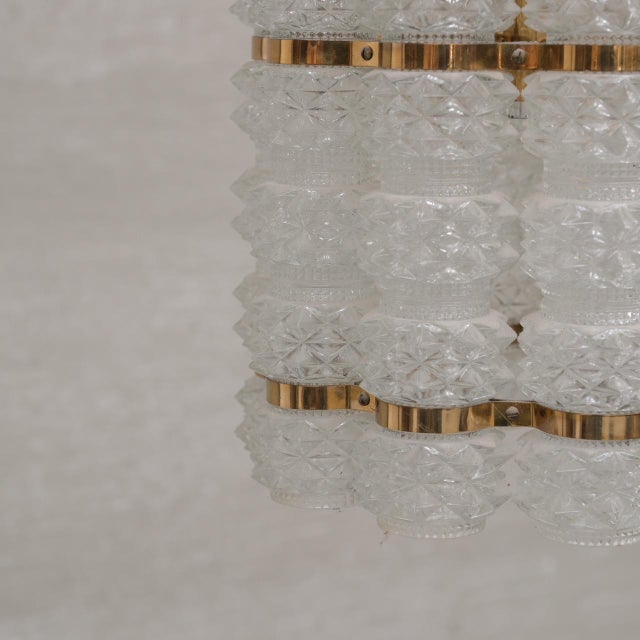 A brass and glass chandelier by orrefors for tyringe, sweden. sweden, c1960s. the chain can be added too upon request....