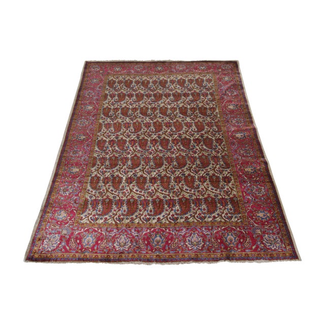 A 4x7 antique Persian rug of renowned Kashani origin, honoring classic paisley patterns in prevalent red and beige-brown...
