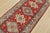 A tribal Caucasian Kazak runner hand-knotted with fine wool on a cotton foundation. This rug features a row of geometric...