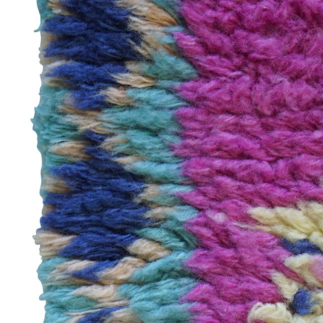 Zuid is a high-pile rug that is plush with texture and bold in color. The hand-crafted rug has a palette of deep fuchsia,...