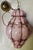 This is an absolutely fantastic white glass cased in mottled pink glass, hand blown into a wire cage which, when lighted...