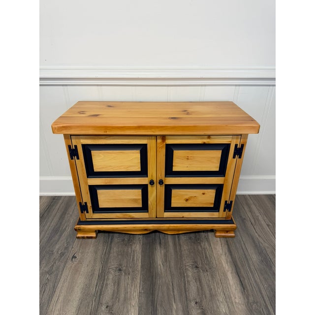 This is an Early American Style Solid Pine Console Cabinet made by the Ethan Allen Company. It's finished natural pine...