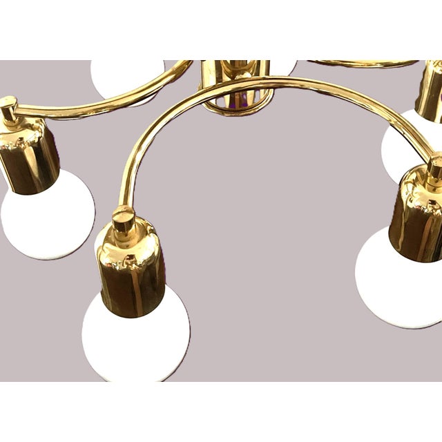 Elegant german mid-century ceiling light from the 1970s, featuring six gracefully curved brass-finished arms and six...