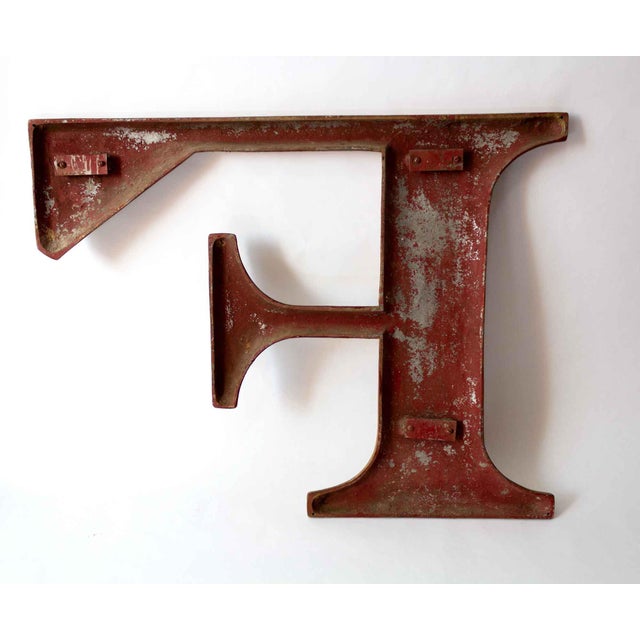Large metal letter F, painted gold. A warm piece with rich texture, we love this as a statement in the entryway or a focal...