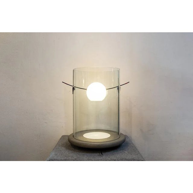 Widespread light table lamp with opal glass diffuser, curved crystal body and serene stone base. The bulling transformer...