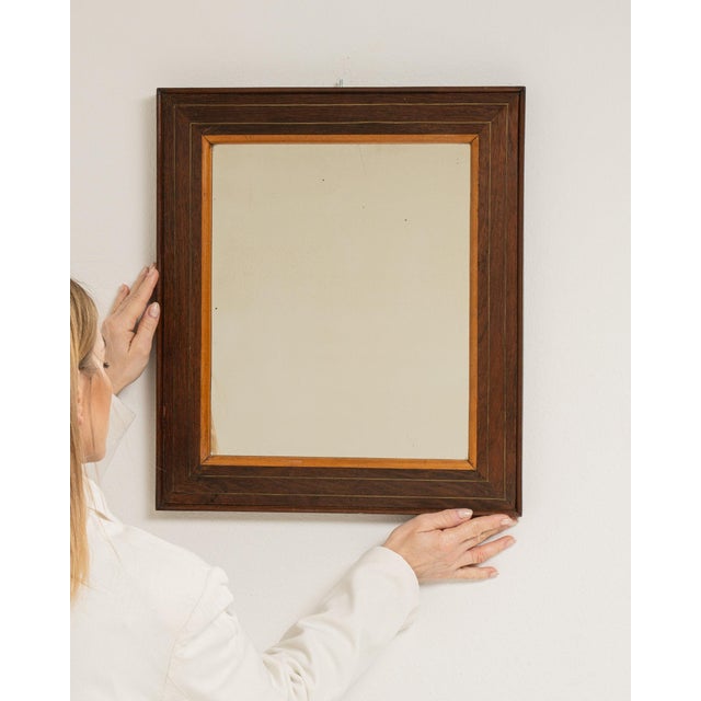 This piece presents as a mirror, distinguished by dark walnut frame, rectangular. Dating to 19th Century and originating...