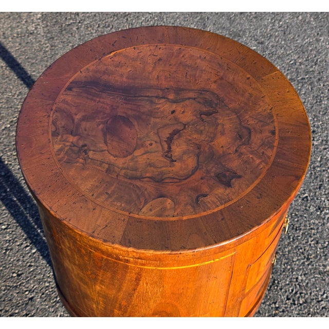 This Late 19th-Century Italian Louis XVI Style Round Walnut Side Table with Inlay & 3 Drawers is a historical and...