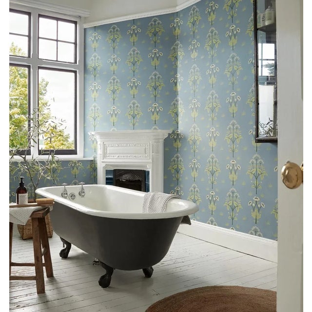 Whimsical and full of nostalgic charm symmetrical plant motifs are formally arranged over this wallpaper typical of the...