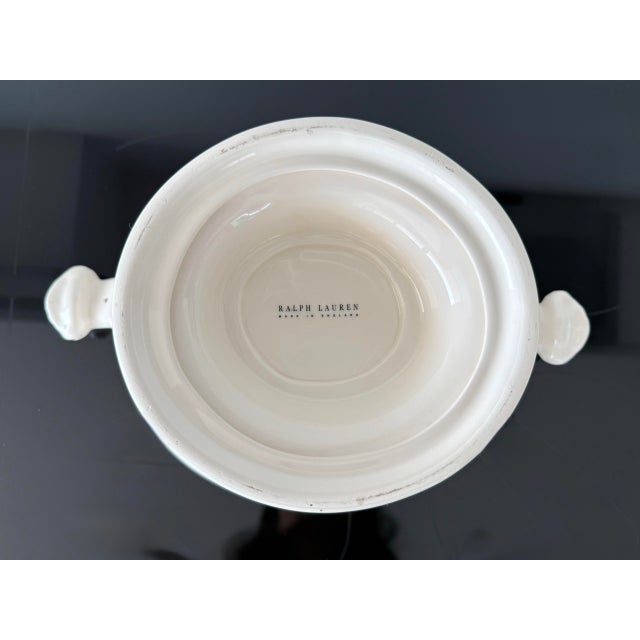 Tureen with lid from the “Dunham” collection by Ralph Lauren Home. This cream earthenware was crafted in England. This...