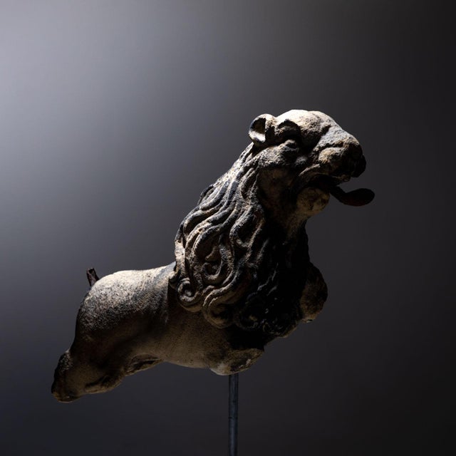 Gothic lion preserved in fragmentary condition with curved iron tongue and long mane. The iron tail is still present as a...