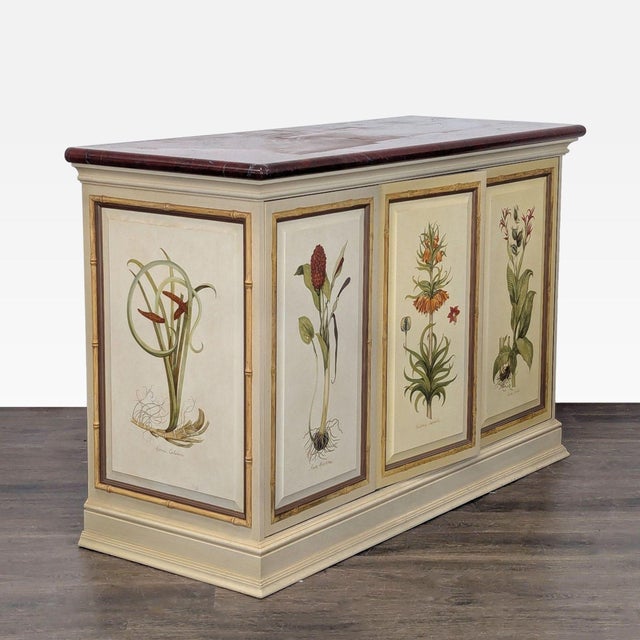 This entertainment center features a classic cream finish with a marble top and hand-painted floral designs on the doors...