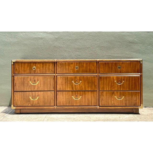 This vintage Drexel Campaign dresser is a quintessential example of mid-century functionalism married to high-end...