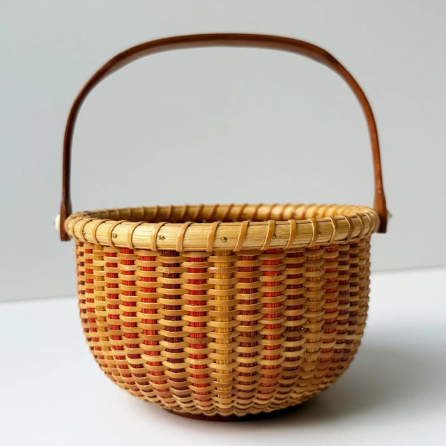 This beautifully handcrafted vintage Nantucket Lightship Basket is a signed piece, marked by the artisan on the underside....