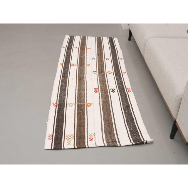Vintage Hand-Knotted runner rug is a semi-antique vintage area rug. The '70s Eastern region of Anatolia's unique rug is...