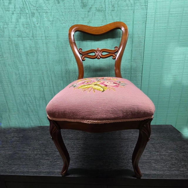 This chair pulls on design features from Victorian, traditional, and shabby chic styles. It features a rounded back and a...