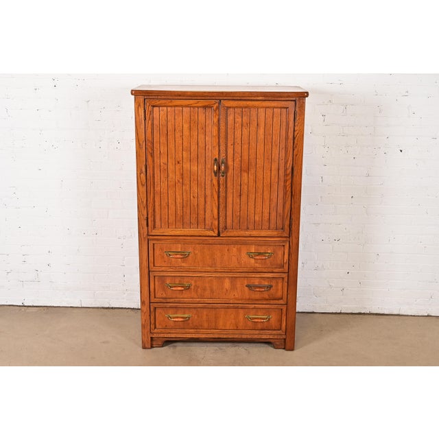 A gorgeous Mid-Century Modern Campaign style armoire dresser or gentleman's chest By Thomasville USA, Circa 1970s Walnut,...