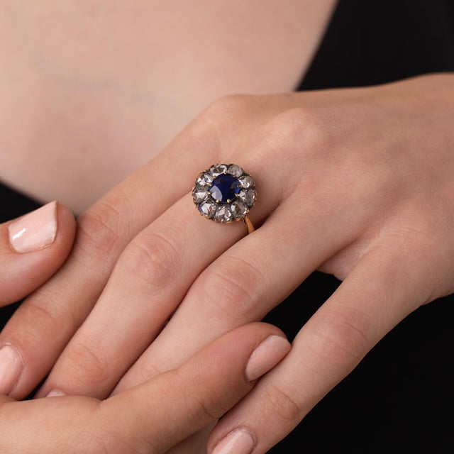 This beautiful Victorian sapphire and diamond ring is a romantic antique jewel from the 1890’s, centered by a GIA-...