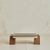 A 1970s Belgian coffee table, defined by the contrast between a honed slate top and solid wood block supports. The top is...